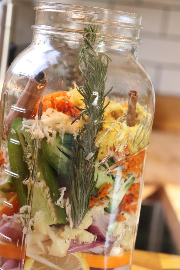 Ingredients in a jar for fire cider.