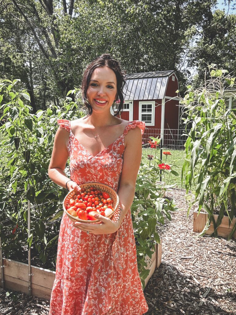 Woman holding basket of veggies.