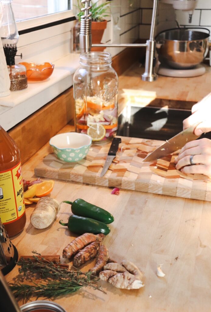 Making fire cider with ingredients all on a cutting board. 