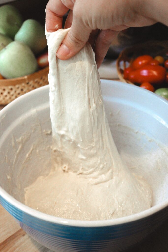 Stretching and folding sourdough bread.